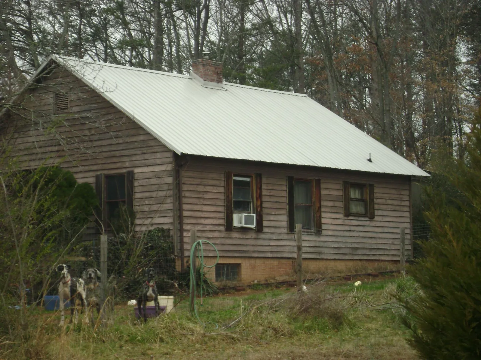 White metal roof on an old wood sided farmhouse, from a Metal Roof Installation job in Hemingway